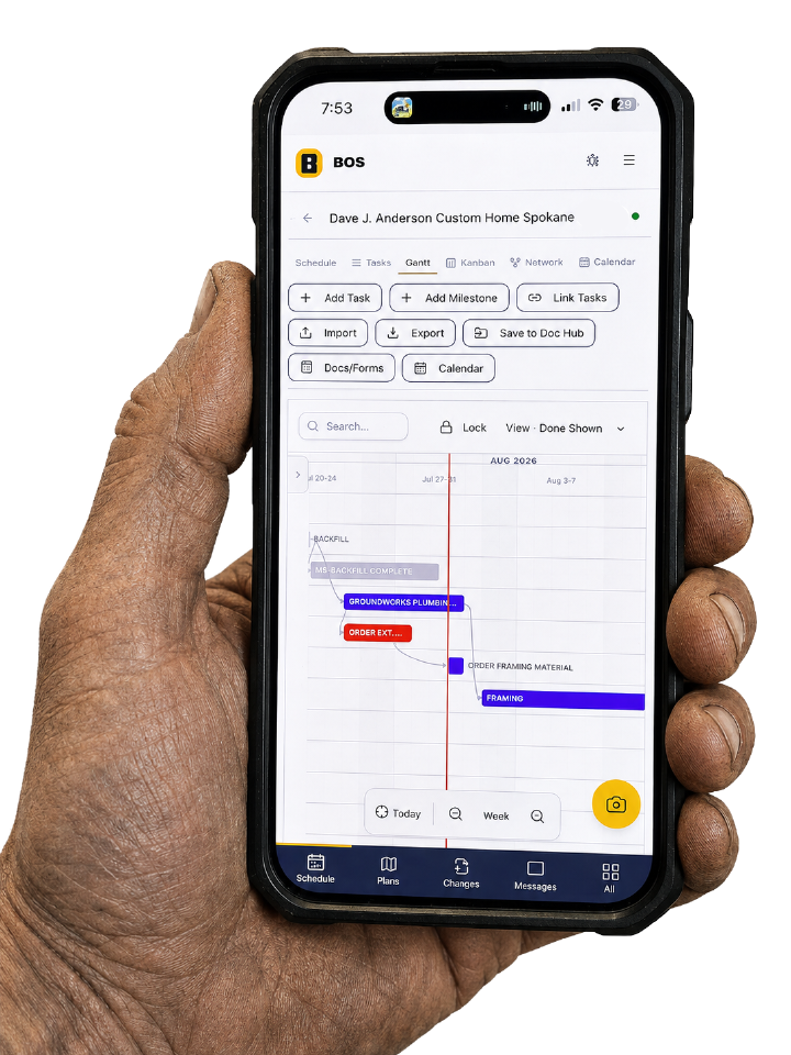 A superintendent holding a phone showing a BOS construction schedule on site